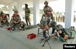 Afghan women army cadets shoot a target during practice at the Officers Training Academy as part of the Indian military training program for women Afghan army cadets, in Chennai, India, Dec. 19, 2018.