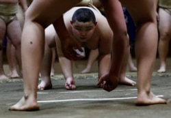 Kyuta Kumagai, 10, trains on a Dohyo, a traditional ring in which sumo wrestling bouts are held, at Komatsuryu Sumo Club in Tokyo, Japan, December 6, 2020. (REUTERS/Kim Kyung-Hoon)