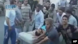 REUTERS CANNOT INDEPENDENTLY VERIFY CONTENT OF THE VIDEO FROM WHICH THIS STILL IMAGE WAS TAKEN.
A man on a stretcher is carried to Al Badra Hospital in Hama in this still image taken from video July 31, 2011