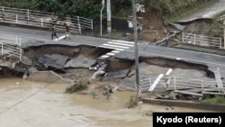 A broken road after heavy rain in Kurashiki, Okayama Prefecture, Japan, July 8, 2018.