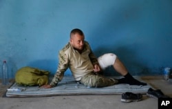 A pro-Ukrainian fighter is held in a garage in the eastern Ukraine town of Novoazovsk Aug. 29, 2014.
