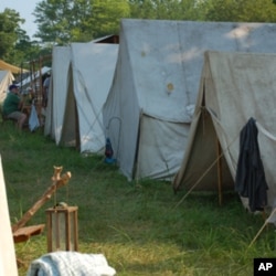 Arriving a day or two before the battle, the re-enactors set up camp in nearby fields, pitching white canvas tents.