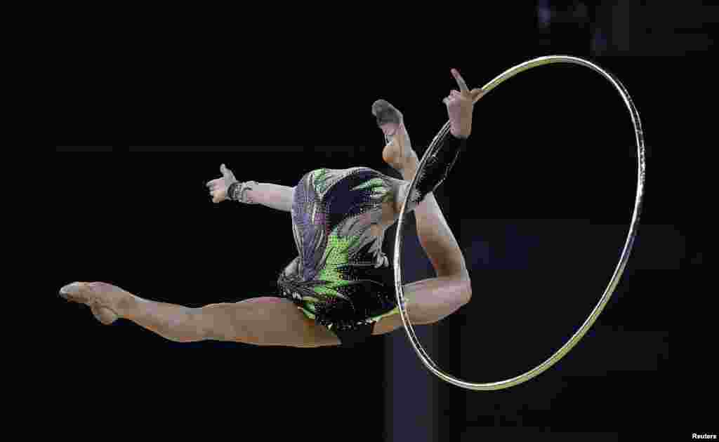 Laura Halford of Wales jumps during her hoop routine as she competes in the rhythmic gymnastics individual all-around final event at the 2014 Commonwealth Games in Glasgow, Scotland.