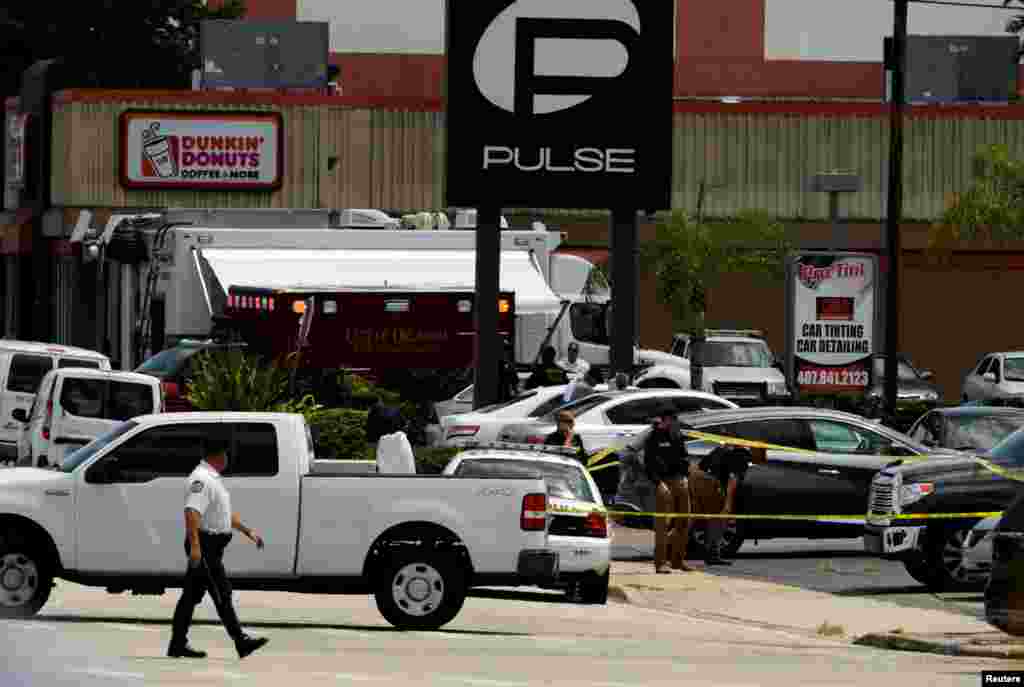 Police continue to investigate a shooting at the Pulse night club following an early morning shooting attack in Orlando, Florida, June 12, 2016. 