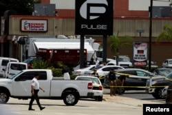 Police continue to investigate a shooting at the Pulse night club following an early morning shooting attack in Orlando, Florida, June 12, 2016.