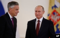 U.S. Ambassador Jon Huntsman, left, is pictured after presenting credentials to Russian President Vladimir Putin during a ceremony in the Kremlin in Moscow, Oct. 3, 2017.