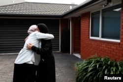 Zahra Fathy, widow of 70-year-old Hussein Moustafa, an Egyptian immigrant who lost his life in the Christchurch shootings, embraces a neighbor in Christchurch, New Zealand, March 30, 2019.