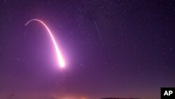 FILE - This image taken with a slow shutter speed on Oct. 2, 2019, and provided by the U.S. Air Force shows an unarmed Minuteman 3 intercontinental ballistic missile test launch at Vandenberg Air Force Base, Calif. 