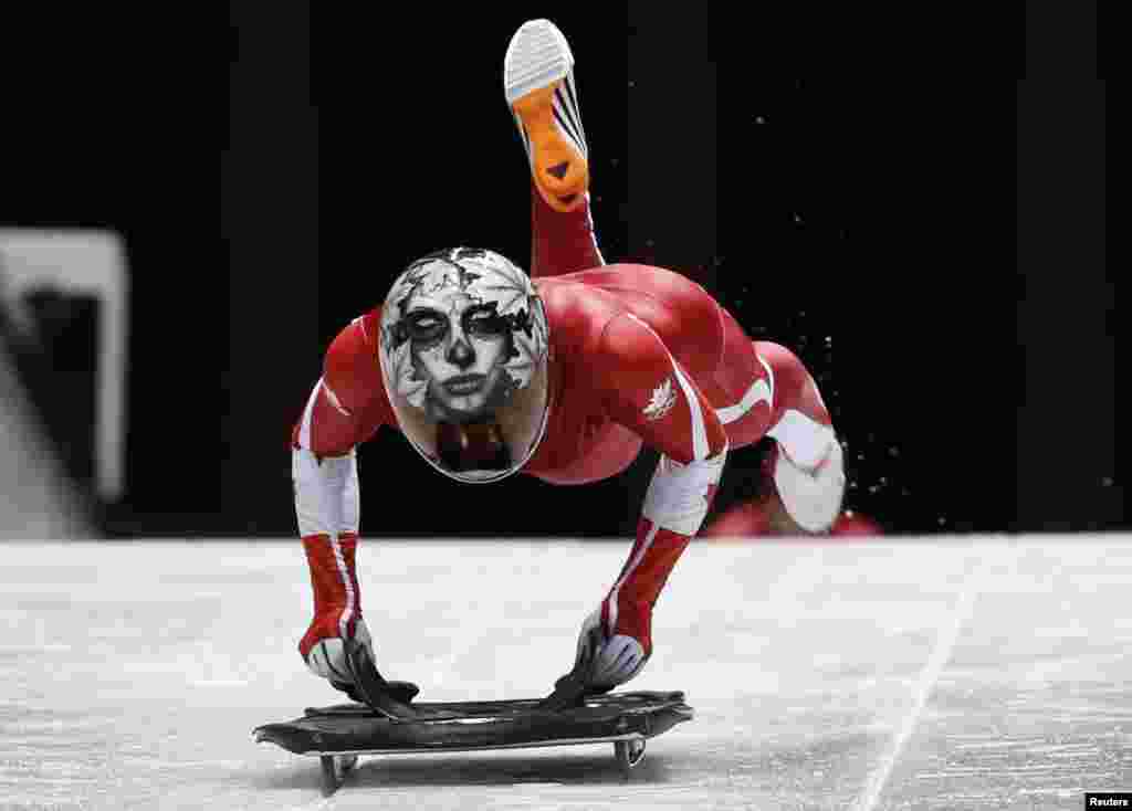 Canada&#39;s Sarah Reid speeds down the track during an unofficial women skeleton progressive training at the Sanki sliding center in Rosa Khutor, a venue for the Sochi 2014 Winter Olympics near Sochi, Russia.