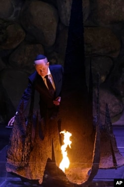 FILE - German Chancellor Olaf Scholz participates in a ceremony commemorating the six million Jews killed in the Holocaust, in the Hall of Remembrance at the Yad Vashem World Holocaust Remembrance Center in Jerusalem, March 2, 2022.
