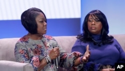 FILE - Sybrina Fulton, the mother of Trayvon Martin, left, speaks nex to Rev. Wanda Johnson, the mother of Oscar Grant, at the My Brother's Keeper Alliance Summit in Oakland, Calif., Feb. 19, 2019. 