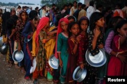 Korban banjir berkumpul untuk menerima bantuan makanan di sebuah kamp, menyusul hujan dan banjir selama musim hujan di Sehwan, Pakistan, 15 September 2022. (Foto: REUTERS/Akhtar Soomro)