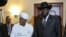 Sudanese President Omar al-Bashir (Center L) smiles after shaking hands with his South Sudanese counterpart Salva Kiir following a meeting in the Ethiopian capital, Addis Ababa, July 14, 2012. 