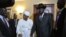 Sudanese President Omar al-Bashir (Center L) smiles after shaking hands with his South Sudanese counterpart Salva Kiir (Center R) following a meeting in the Ethiopian capital Addis Ababa, July 14, 2012. 