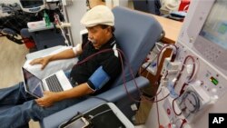 FILE - Adrian Perez undergoes dialysis at a DaVita Kidney Care clinic in Sacramento, Calif., Sept. 24, 2018.