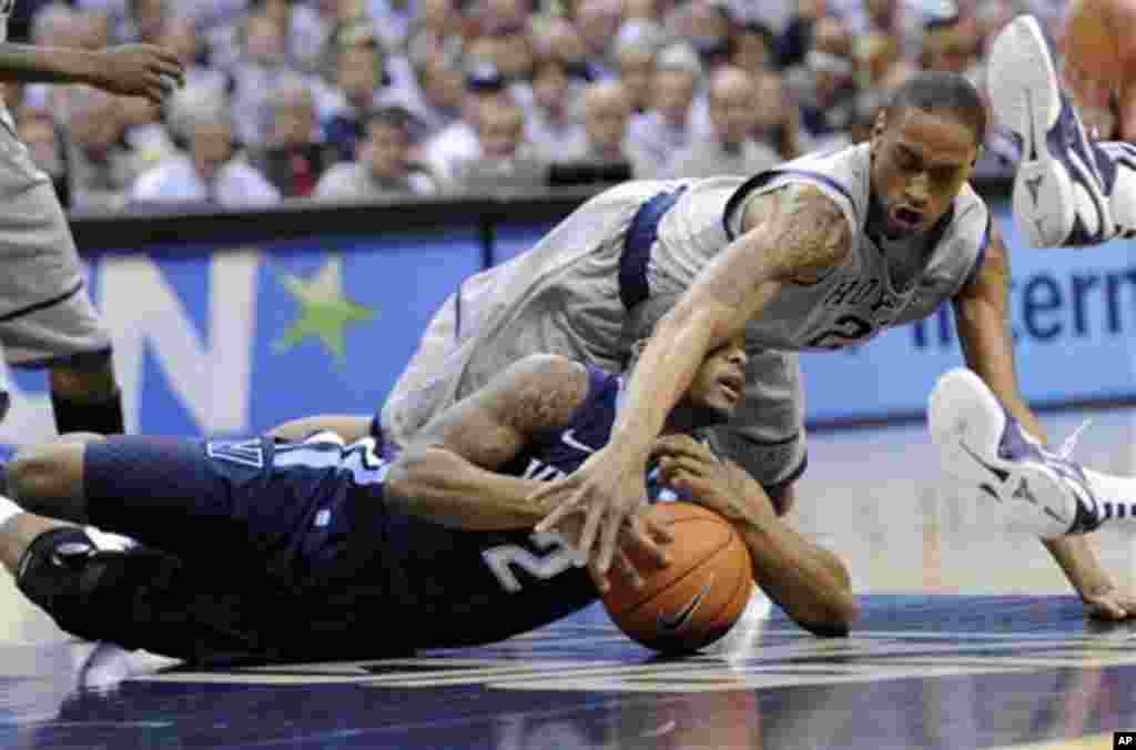 Georgetown forward Greg Whittington, top, fights for a loose ball with Villanova guard Maalik Wayns, bottom, during the first half of an NCAA college basketball game, Saturday, Feb. 25, 2012, in Washington.