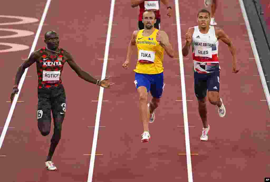 Ferguson Rotich, of Kenya, left, races to the line to win a semifinal of the men&#39;s 800-meter ahead of Amel Tuka, of Bosnia and Herzegovina, center, and Elliot Giles, of Britain at the 2020 Summer Olympics, Sunday, Aug. 1, 2021, in Tokyo, Japan. (AP Photo/Charlie Riedel)