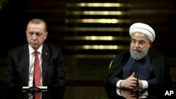 Iranian President Hassan Rouhani (R) speaks with media during a joint press conference with Turkish President Recep Tayyip Erdogan after their meeting at the Saadabad Palace in Tehran, Iran, Oct. 4, 2017.