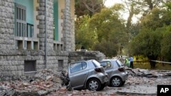 Damaged cars outside the Faculty of Geology building after an earthquake in Tirana, Sept. 21, 2019. Albania's government and news reports say an earthquake with a preliminary magnitude of 5.8 shook in the country's west and injured at least two people.