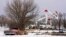 FILE - Utility workers from Xcel Energy tend to power lines near a home destroyed by the Smokehouse Creek fire on Feb. 29, 2024, in Stinnett, Texas. Xcel said on March 7 that its facilities appeared to have played a role in igniting the massive wildfire.