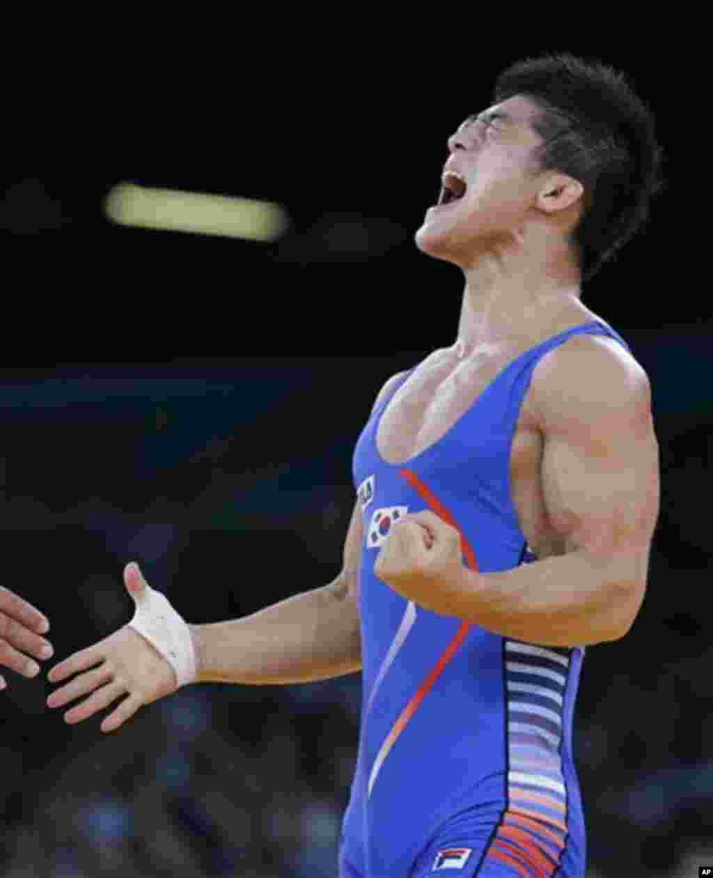 South Korea's Kim Hyeon-woo celebrates after defeating Hungary's Tamas Lorincz in their gold medal match in 66-kg Greco-Roman wrestling competition at the 2012 Summer Olympics, Tuesday, Aug. 7, 2012, in London. (AP Photo/Paul Sancya)