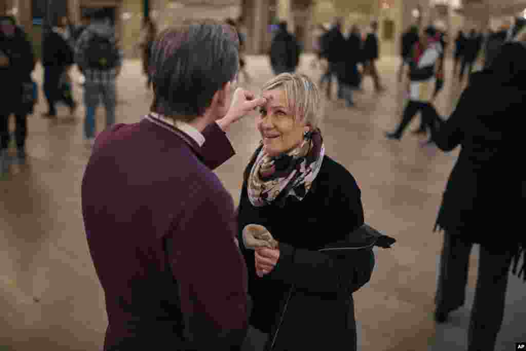 Rev. Matthew Heyd, the 17th Episcopal Bishop of New York, offers Ashes to Go at Grand Central Station in New York.