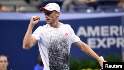 Petenis Australia John Millman merayakan kemenangan atas Roger Federer dalam laga enam set di turnamen tenis AS Terbuka di New York, AS, 3 September 2018.