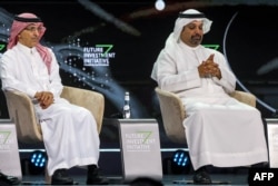 FILE - Saudi Finance Minister Mohammed al-Jadaan (L) and his Bahraini counterpart Salman bin Khalifa al-Khalifa attend a panel panel at the annual Future Investment Initiative (FII) conference in Riyadh on October 25, 2023.