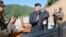 This image made from video aired by North Korea's KRT, July 4, 2017, shows what was said to be North Korea leader Kim Jong Un, center, applauding after the launch of a Hwasong-14 intercontinental ballistic missile in North Korea's northwest.