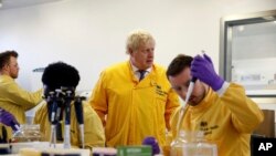 Britain's Prime Minister Boris Johnson visits a laboratory at the Public Health England National Infection Service, after more than 10 new coronavirus patients were identified in England, in Colindale, north London, March 1, 2020.