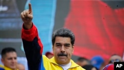 FILE - Venezuela's President Nicolas Maduro lead a rally condemning the economic sanctions imposed by the administration of U.S. President Donald Trump on Venezuela, in Caracas, Venezuela, Aug. 10, 2019.