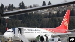 A brand-new Shenzhen Airlines Boeing 737 Max 8 airplane sits parked at Boeing Field, March 14, 2019, in Seattle. 