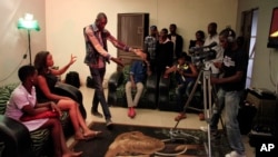 FILE - Nollywood actors perform a scene for a movie in Lagos, Nigeria.