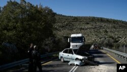 FILE - Israeli security forces examine the scene of a Palestinian shooting attack, near Wadi al-Haramiya, West Bank, January 7, 2024.