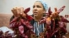 Chahida Boufaied, owner of Dar Chahida Lel Oula, prepares the Harissa in her house in Nabeul, Tunisia, Jan. 7, 2025.