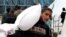 FILE—A Palestinian boy carries a bag of flour distributed by the United Nations Relief and Works Agency (UNRWA), amid the ongoing conflict between Israel and Hamas, in Rafah in the southern Gaza Strip January 29, 2024.