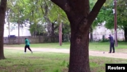 FILE - North Charleston police Officer Michael Slager, right, is seen shooting 50-year-old Walter Scott in the back as he runs away, in this still image from video in North Charleston, South Carolina, taken April 4, 2015. 