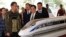 Tổng thống Indonesia Joko Widodo (thứ 2 từ trái qua) và tổng giám đốc Tập đoàn Đường sắt Trung Quốc Thịnh Quang Tổ đứng bên mô hình một chiếc tàu tại lễ động thổ tuyến đường sắt nhanh Jakarta-Bandung ở Walini, Tây Java. Đây là một dự án trong sáng kiến Vành đai và Con đường.