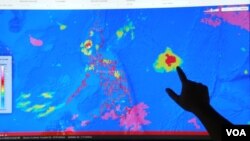Project NOAH Executive Director Mahar Lagmay points at a satellite image of a tropical depression approaching the Philippines at the National Institute of Geological Sciences, University of the Philippines Diliman campus, Sept. 20, 2012. (VOA/Simone Orendain)
