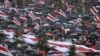People take cover from rain under umbrellas during an opposition rally to protest against police brutality and to reject the presidential election results in Minsk, Belarus, Sept.r 6, 2020. 