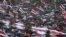People take cover from rain under umbrellas during an opposition rally to protest against police brutality and to reject the presidential election results in Minsk, Belarus, Sept.r 6, 2020. 