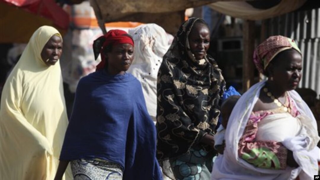 Niger women walk on a street in Niamey, Niger.