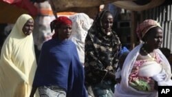 Niger women walk on a street in Niamey, Niger.