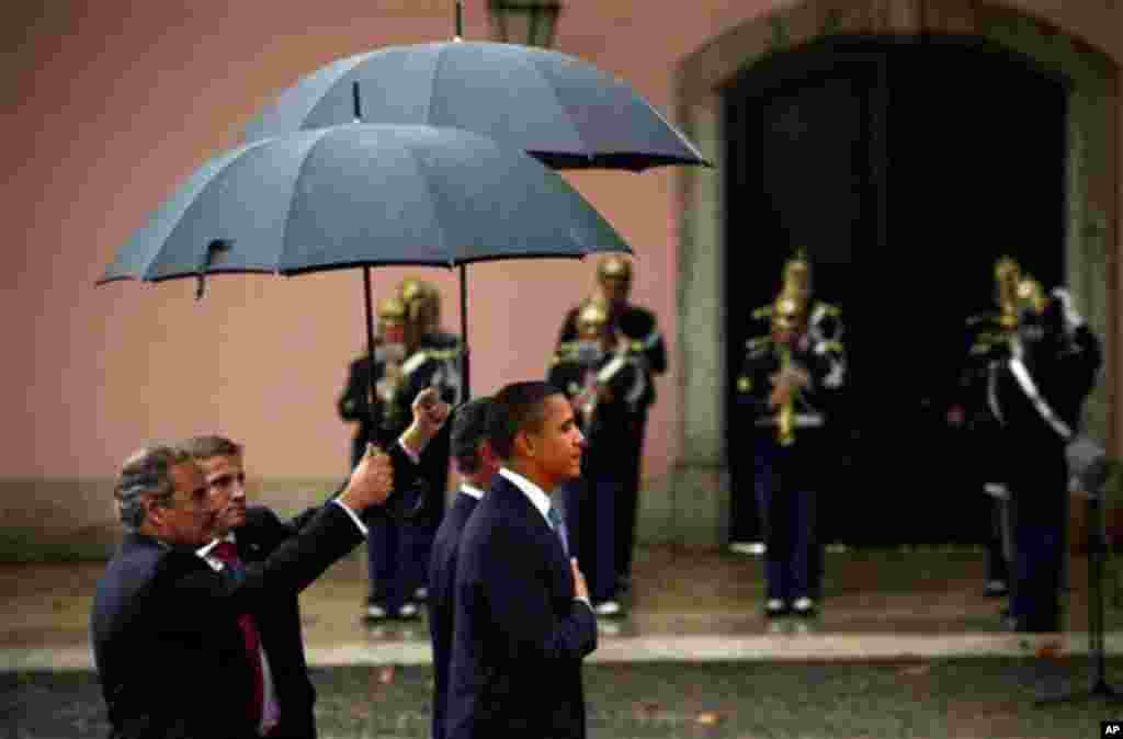 Nov. 19: President Barack Obama listens to the American national anthem next to Portuguese President Anibal Cavaco Silva during the arrival ceremony at the Belem National Palace in Lisbon, Portugal.  (AP Photo/Victor R. Caivano)