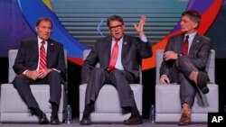 U.S. Energy Secretary Rick Perry, center, speaks as Utah Gov. Gary Herbert, left, and and Wyoming Gov. Mark Gordon look on at an energy summit, May 30, 2019, in Salt Lake City. 