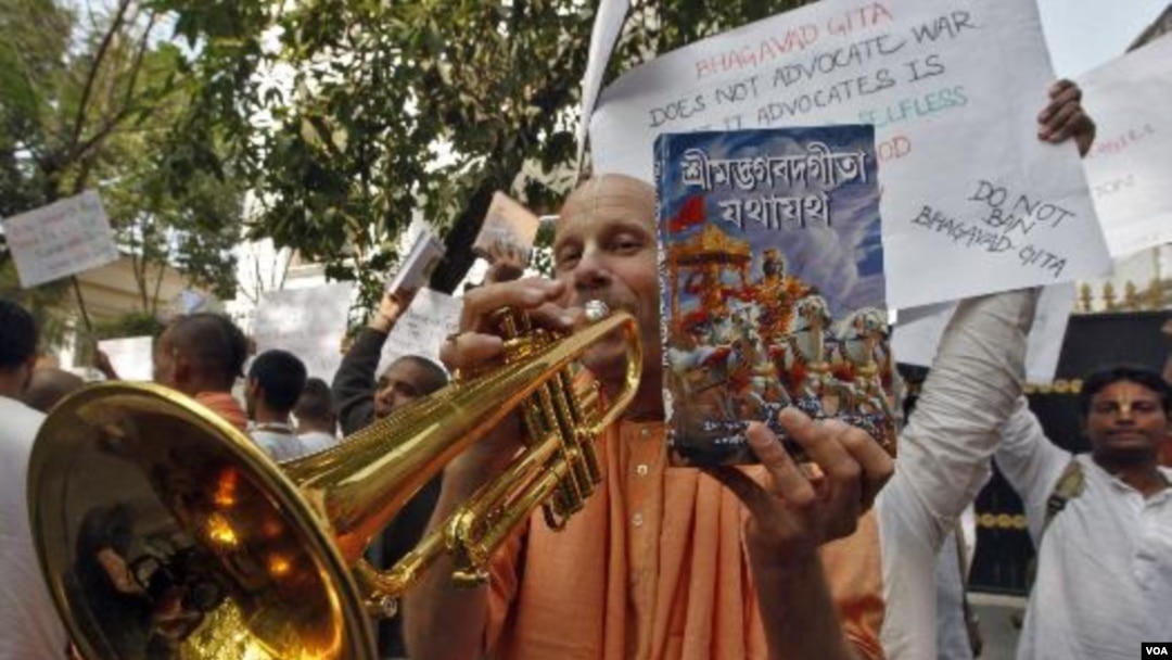 Seorang anggota sekte global Hare Krishna memainkan terompetnya selama protes di luar konsulat Rusia di Kolkata (19/12). Parlemen India dan pengunjuk rasa berkumpul di luar konsulat Rusia menentang pelarangan kitab Bhagavad Gita.