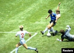 FILE - Argentina's Diego Maradona scores against England in the quarter final of the FIFA World Cup, Azteca Stadium, Mexico City, June 22, 1986. (Action Images via Reuters)