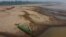 Reis Santo Vieira paints a boat on a dry part of the Madeira River, a tributary of the Amazon River, during the dry season in Humaita, Amazonas state, Brazil, Sept. 7, 2024. 