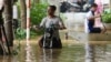 A man pushes his motorbike in a flooded street in the aftermath of Typhoon Yagi, in Hanoi, Vietnam, Sept. 12, 2024. 