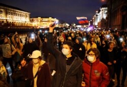 FILE - Demonstrators march during a rally in support of jailed Russian opposition politician Alexey Navalny, in Saint Petersburg, Russia, April 21, 2021.